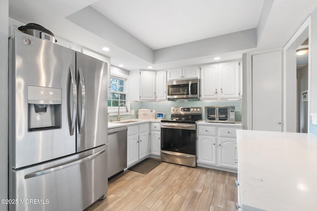 5 Poplar St, Jackson, NJ 08527 - kitchen with stainless steel appliances, light countertops, white cabinets, decorative backsplash, and recessed lighting