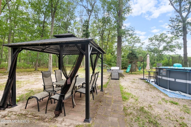 5 Poplar St, Jackson, NJ 08527 - view of yard featuring a gazebo, view of wooded area, outdoor dining area, a patio, and an outdoor pool