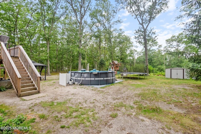5 Poplar St, Jackson, NJ 08527 - view of yard featuring stairs, a storage unit, an outdoor pool, and a trampoline