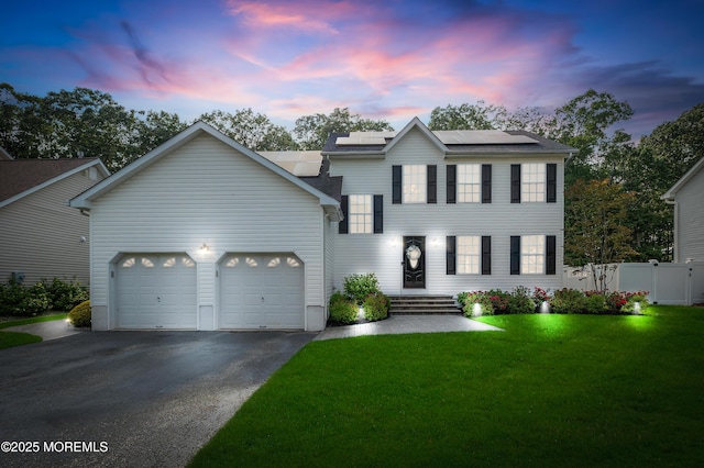 36 Sally St, Howell, NJ 07731 - view of front of home with driveway, a garage, and roof mounted solar panels