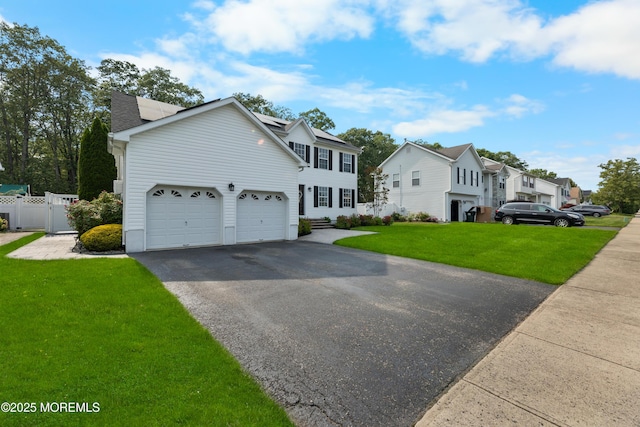 36 Sally St, Howell, NJ 07731 - view of front of house featuring asphalt driveway, roof mounted solar panels, a residential view, and an attached garage