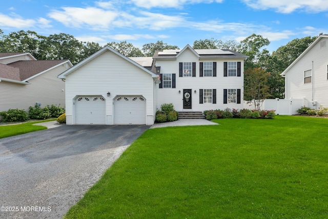 36 Sally St, Howell, NJ 07731 - view of front of property featuring asphalt driveway, solar panels, and a garage