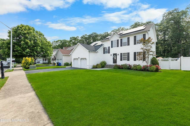 36 Sally St, Howell, NJ 07731 - view of front of home featuring asphalt driveway, solar panels, and a garage