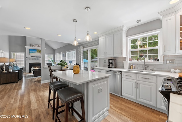 36 Sally St, Howell, NJ 07731 - kitchen featuring dishwasher, white cabinetry, light countertops, decorative backsplash, and lofted ceiling