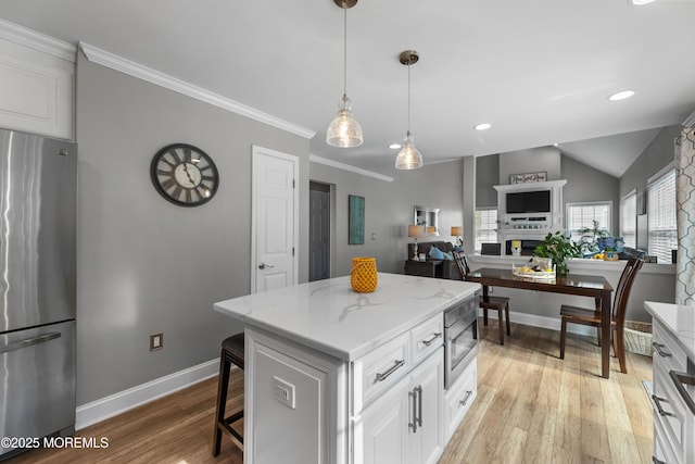 36 Sally St, Howell, NJ 07731 - kitchen with appliances with stainless steel finishes, light wood-style flooring, white cabinets, light stone countertops, and hanging light fixtures