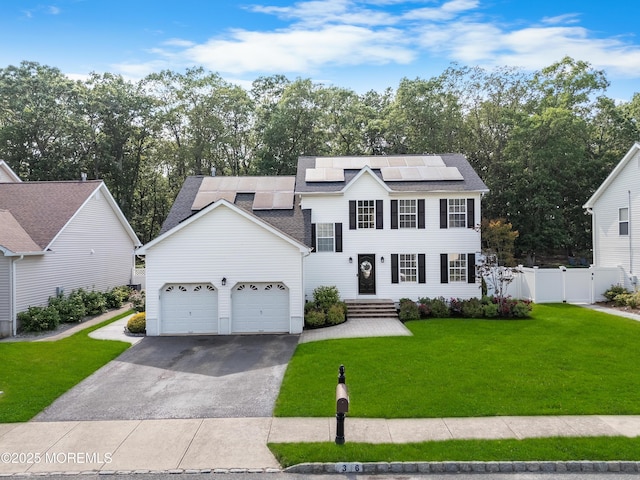36 Sally St, Howell, NJ 07731 - view of front of property with asphalt driveway, solar panels, a garage, a shingled roof, and view of wooded area