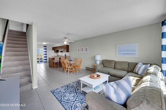 3100 Rte 35 Unit 6, Lavallette, NJ 08735 - living room featuring stairway, light tile patterned floors, baseboard heating, a ceiling fan, and a textured ceiling