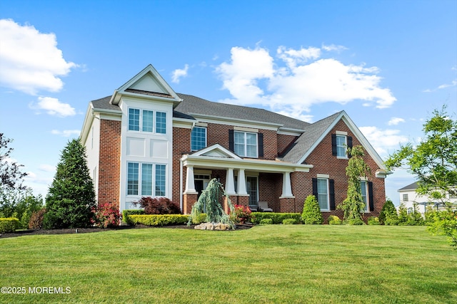 11 Potomac Ct, Freehold, NJ 07728 - view of front facade with brick siding, a front yard, a porch, and roof with shingles