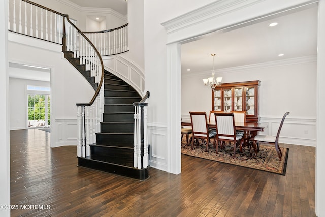 11 Potomac Ct, Freehold, NJ 07728 - staircase featuring hardwood / wood-style floors, a chandelier, a decorative wall, wainscoting, and crown molding