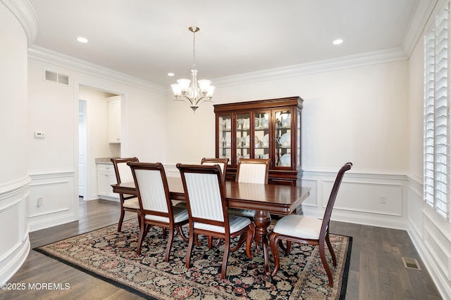 11 Potomac Ct, Freehold, NJ 07728 - dining area with a chandelier, dark wood-type flooring, a wainscoted wall, ornamental molding, and a decorative wall