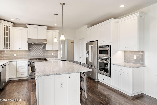 11 Potomac Ct, Freehold, NJ 07728 - kitchen with premium appliances, dark wood-type flooring, a kitchen island, under cabinet range hood, and white cabinets