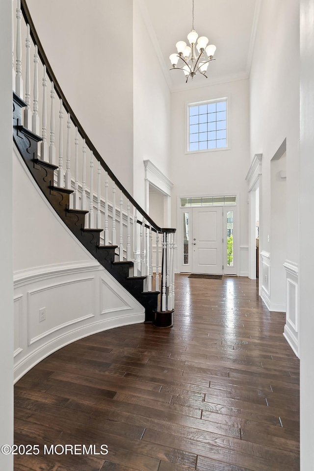 11 Potomac Ct, Freehold, NJ 07728 - foyer with a towering ceiling, stairway, a chandelier, ornamental molding, and hardwood / wood-style flooring