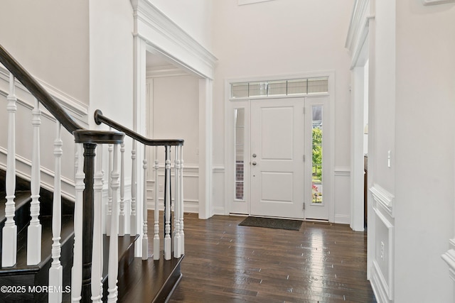 11 Potomac Ct, Freehold, NJ 07728 - entryway featuring stairs, dark wood-style flooring, a high ceiling, a decorative wall, and wainscoting