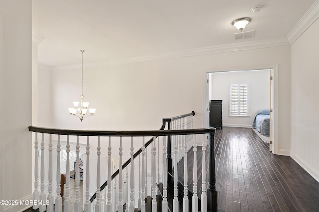 11 Potomac Ct, Freehold, NJ 07728 - corridor with an upstairs landing, a chandelier, crown molding, and dark wood-style floors