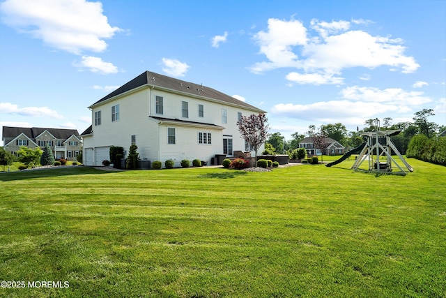 11 Potomac Ct, Freehold, NJ 07728 - back of property with a lawn, a playground, and an attached garage