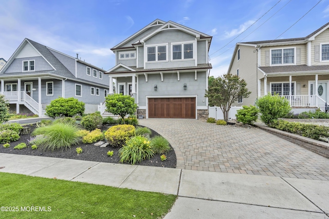 209 Sanborn Ave, Point Pleasant Beach, NJ 08742 - view of front of home with an attached garage, stone siding, and decorative driveway
