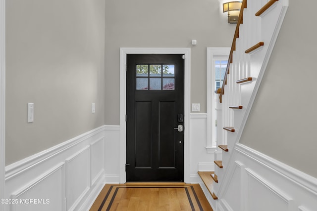 209 Sanborn Ave, Point Pleasant Beach, NJ 08742 - foyer featuring a decorative wall, stairs, light wood finished floors, and wainscoting