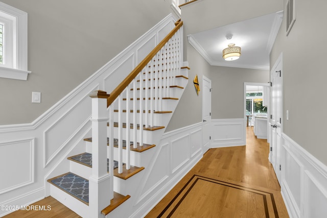 209 Sanborn Ave, Point Pleasant Beach, NJ 08742 - stairs with a decorative wall, wood finished floors, crown molding, and a wainscoted wall