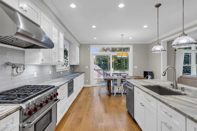 209 Sanborn Ave, Point Pleasant Beach, NJ 08742 - kitchen with under cabinet range hood, appliances with stainless steel finishes, ornamental molding, white cabinetry, and tasteful backsplash