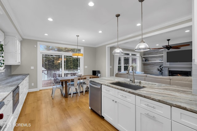 209 Sanborn Ave, Point Pleasant Beach, NJ 08742 - kitchen with stainless steel dishwasher, a ceiling fan, light wood-style flooring, a warm lit fireplace, and recessed lighting