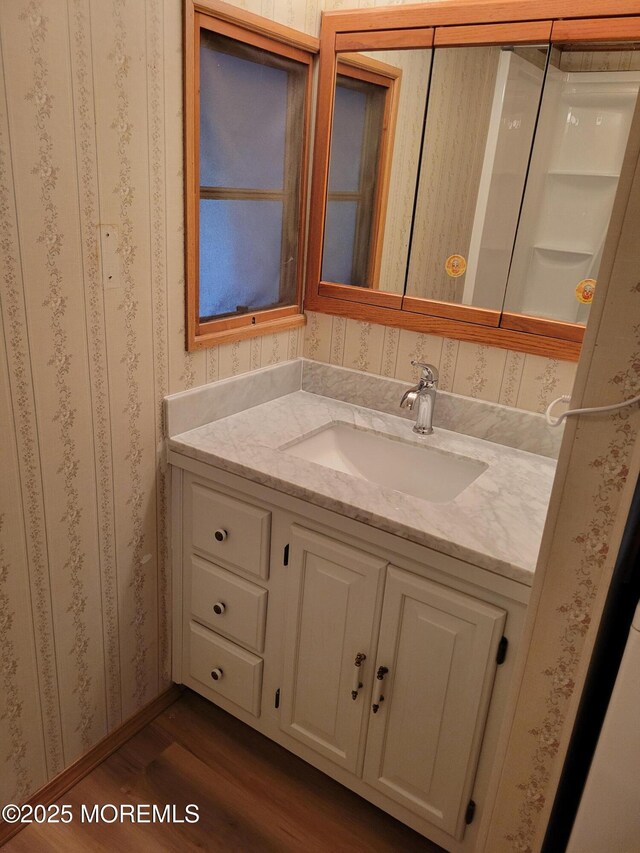 39 Antonia Dr, Jackson, NJ 08527 - bathroom with wood finished floors, vanity, and wallpapered walls