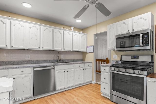 301 Spruce Dr, Brick, NJ 08723 - kitchen featuring stainless steel appliances, a ceiling fan, white cabinetry, tasteful backsplash, and light wood-style floors