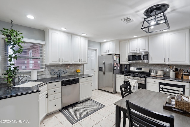12 Briarcliff Ct, Freehold, NJ 07728 - kitchen featuring appliances with stainless steel finishes, dark countertops, white cabinetry, and recessed lighting