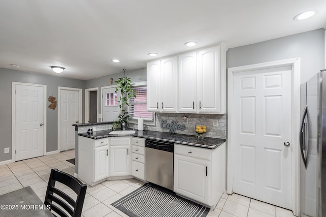 12 Briarcliff Ct, Freehold, NJ 07728 - kitchen with stainless steel appliances, white cabinets, a peninsula, light tile patterned floors, and recessed lighting
