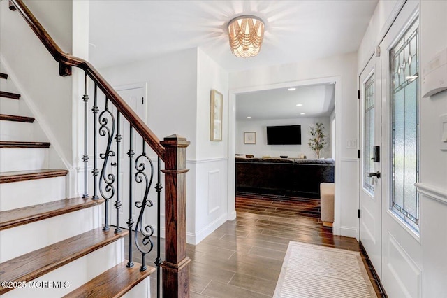 12 Neal Dr, Manalapan, NJ 07726 - foyer with stairway, wood finished floors, a wainscoted wall, recessed lighting, and a chandelier