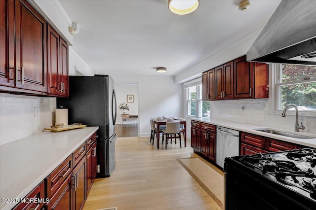 12 Neal Dr, Manalapan, NJ 07726 - kitchen with stainless steel appliances, wall chimney exhaust hood, dark brown cabinets, light wood-style flooring, and light countertops