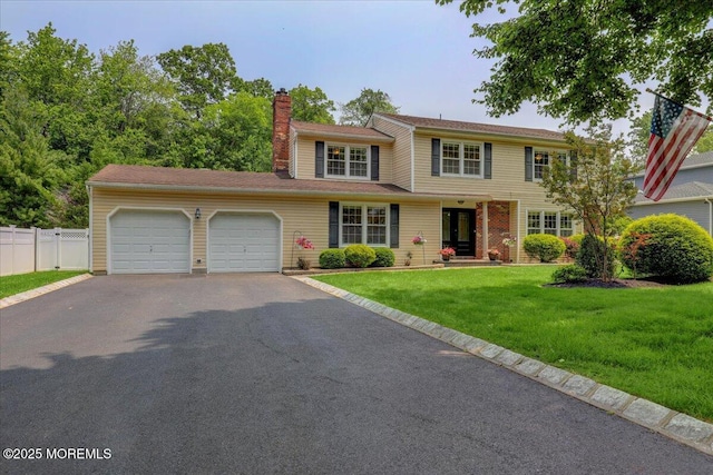 12 Neal Dr, Manalapan, NJ 07726 - view of front of property with a garage, driveway, and a chimney