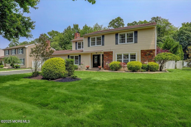 12 Neal Dr, Manalapan, NJ 07726 - colonial inspired home featuring a chimney and brick siding