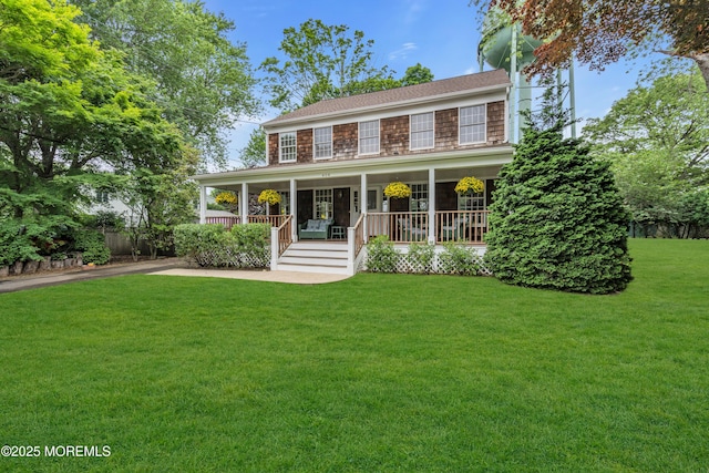 406 Bell Pl, Sea Girt, NJ 08750 - colonial-style house featuring a porch and a front lawn