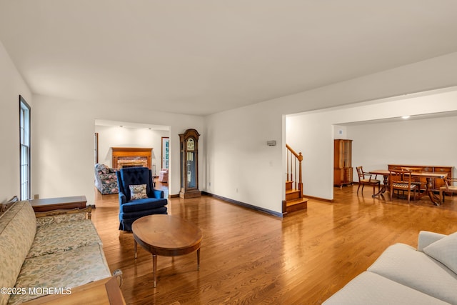 406 Bell Pl, Sea Girt, NJ 08750 - living room featuring stairway, wood finished floors, and a brick fireplace