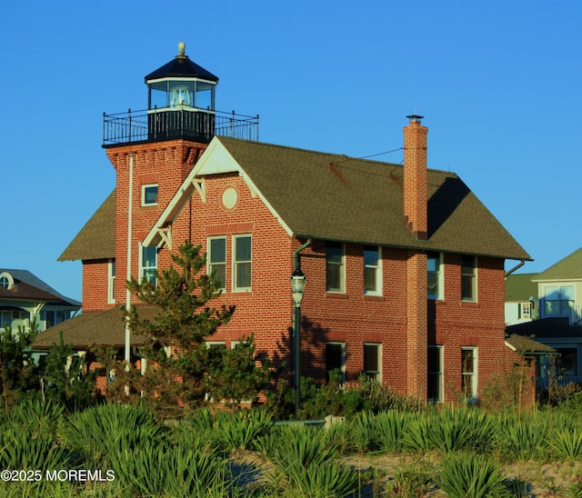 406 Bell Pl, Sea Girt, NJ 08750 - back of property featuring a chimney, brick siding, and roof with shingles
