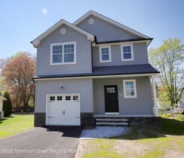 910 Malden Dr, Cliffwood, NJ 07735 - craftsman-style home featuring an attached garage, driveway, a front yard, and a porch