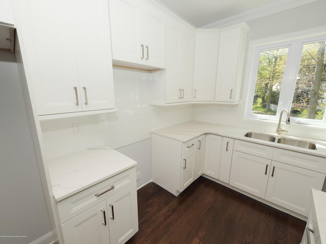 910 Malden Dr, Cliffwood, NJ 07735 - kitchen with light stone counters, dark wood-style flooring, white cabinets, tasteful backsplash, and ornamental molding
