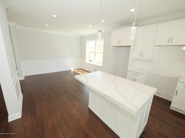 910 Malden Dr, Cliffwood, NJ 07735 - kitchen featuring crown molding, light stone countertops, a kitchen island, white cabinetry, and dark wood-style floors