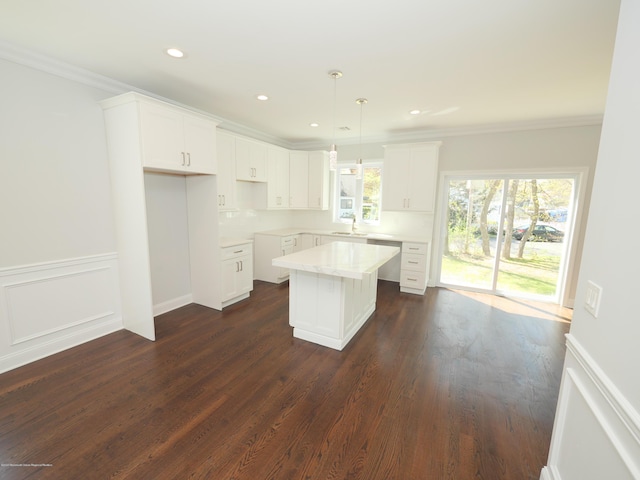 910 Malden Dr, Cliffwood, NJ 07735 - kitchen featuring a center island, crown molding, dark wood finished floors, white cabinetry, and decorative light fixtures