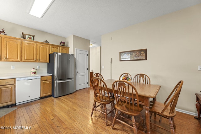 17 Evergreen Springs Dr, Lakewood, NJ 08701 - kitchen with dishwasher, freestanding refrigerator, light wood-style floors, light countertops, and a textured ceiling
