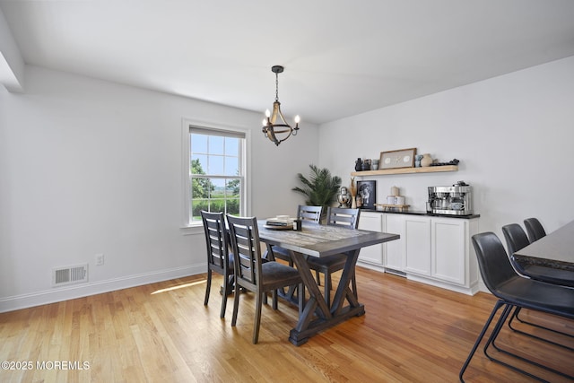 623 Park Ave, Port Monmouth, NJ 07758 - dining room with a chandelier and light wood finished floors
