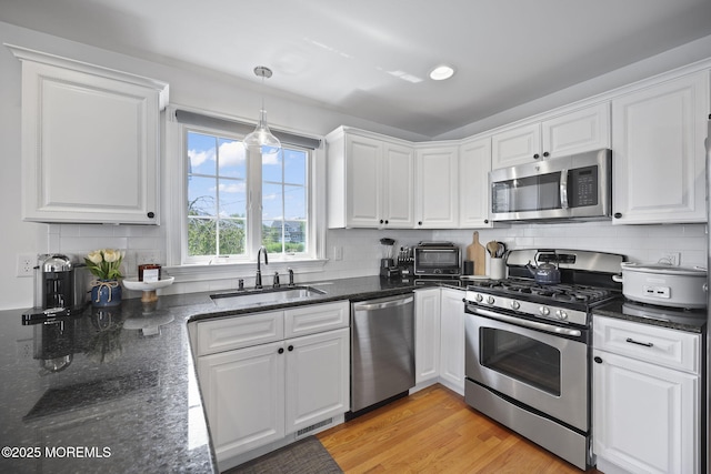 623 Park Ave, Port Monmouth, NJ 07758 - kitchen featuring stainless steel appliances, white cabinetry, and decorative backsplash