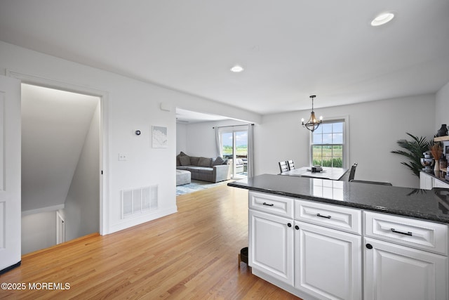 623 Park Ave, Port Monmouth, NJ 07758 - kitchen featuring white cabinets, a chandelier, light wood finished floors, recessed lighting, and hanging light fixtures