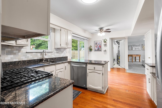 8 Mendon Dr, Howell, NJ 07731 - kitchen featuring stainless steel dishwasher, light wood finished floors, a peninsula, white cabinetry, and decorative backsplash