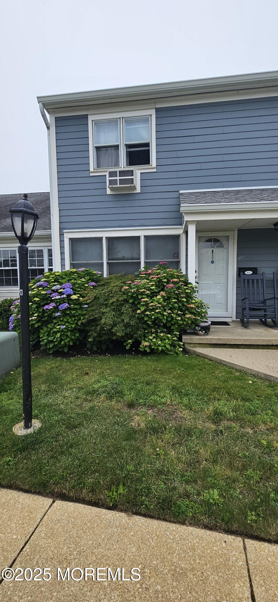 100 Seaview Ave Unit 5A, Monmouth Beach, NJ 07750 - view of front of house with a front lawn and cooling unit