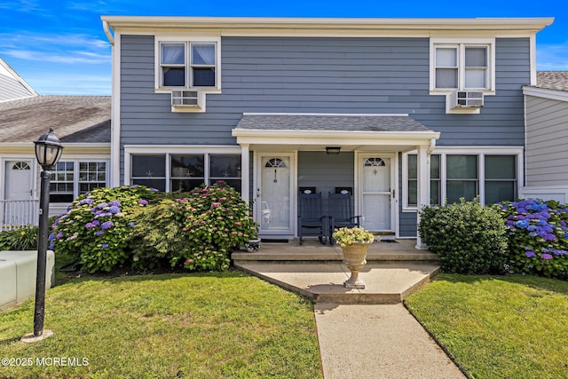 100 Seaview Ave Unit 6-5, Monmouth Beach, NJ 07750 - traditional-style house with a front yard, roof with shingles, and a porch