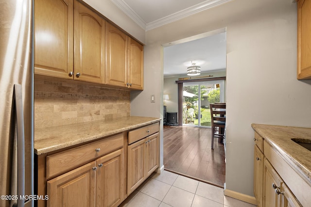 100 Seaview Ave Unit 6-5, Monmouth Beach, NJ 07750 - kitchen featuring ornamental molding, backsplash, light tile patterned floors, freestanding refrigerator, and light stone counters