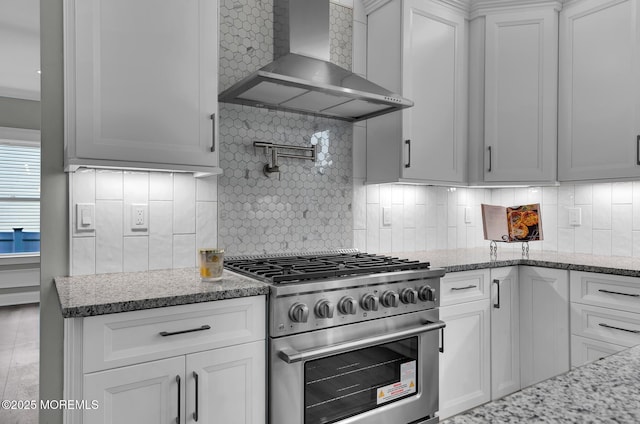817 Naryshkin Way, Toms River, NJ 08753 - kitchen with wall chimney range hood, high end stainless steel range, tasteful backsplash, white cabinetry, and light stone countertops