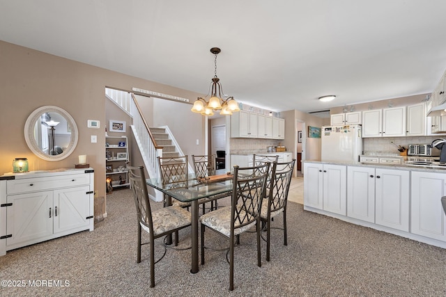 118 S Binnacle Dr, Little Egg Harbor, NJ 08087 - dining space featuring a chandelier, light carpet, and stairway
