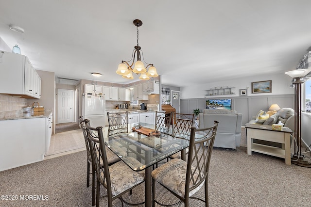 118 S Binnacle Dr, Little Egg Harbor, NJ 08087 - dining space with light carpet and a chandelier